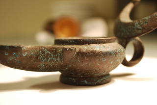 Bronze oil lamp with corrosion