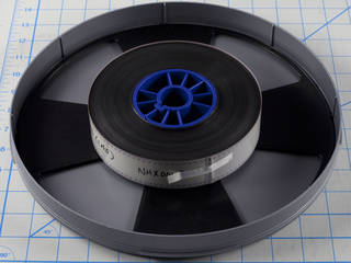 35 millimeter film pack sitting in bottom half of archival plastic container