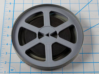 8 millimeter film reel in a metal can