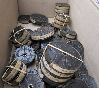 9.5 millimeter film cans in a box