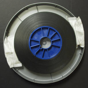 Film with dessicants in vented, inert plastic container