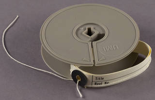 Microfilm reel and button tie