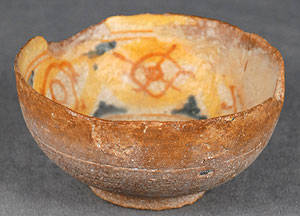 Terracotta bowl with chips and archaeological deposits from soluble salts