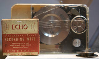 Wire recorder-player with original box and spool in foreground